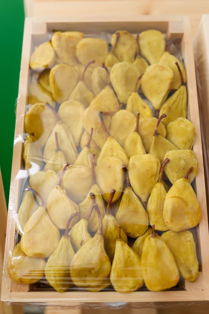 High angle shot of fresh pears packed in a wooden box.