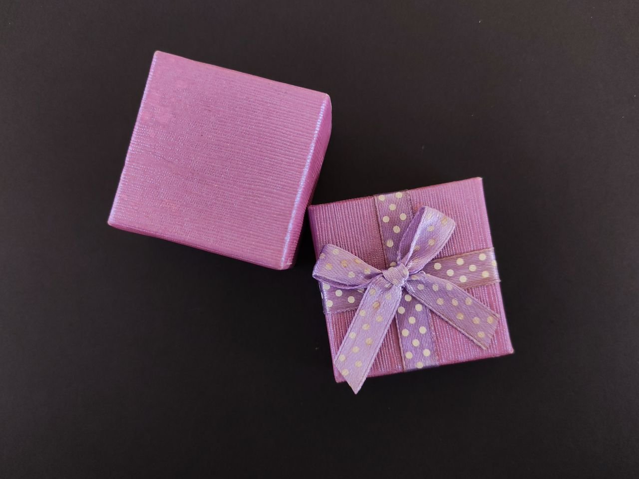 services-02 Elegant purple gift box with polka dot ribbon, perfect for celebrations.